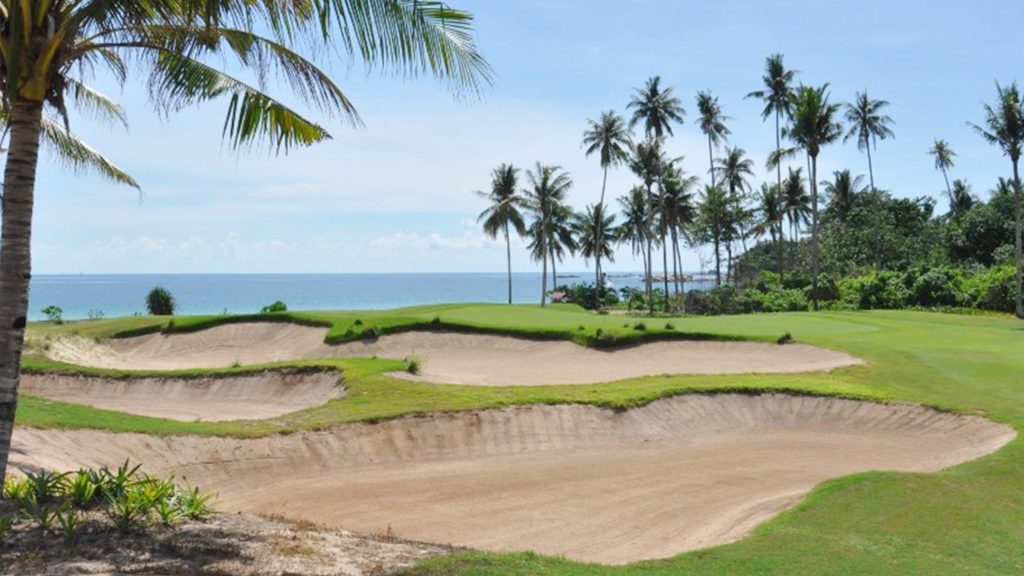 Stunning aerial view of Laguna Golf Bintan surrounded by tropical greenery and ocean views
