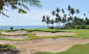 Stunning aerial view of Laguna Golf Bintan surrounded by tropical greenery and ocean views