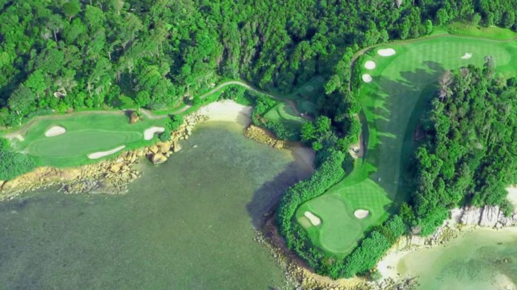 Aerial view of Ria Bintan Golf Club with lush greenery and oceanfront fairways