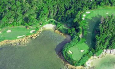 Aerial view of Ria Bintan Golf Club with lush greenery and oceanfront fairways