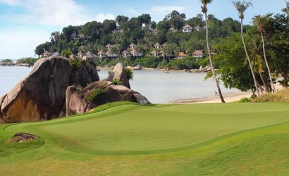 Golfers enjoying a round at Laguna Golf Bintan with scenic oceanfront fairways