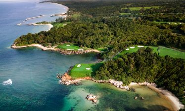 Professional golfer lining up a shot on the immaculate greens of Ria Bintan Golf Club
