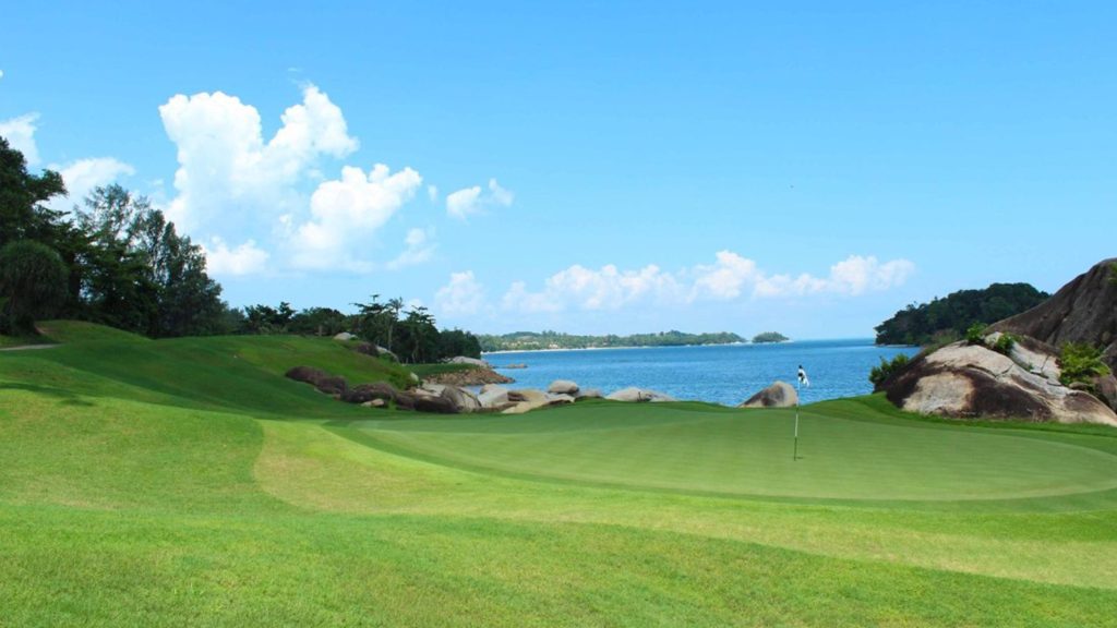 Beautifully manicured fairways at Laguna Golf Bintan, overlooking the turquoise waters of Bintan Island.