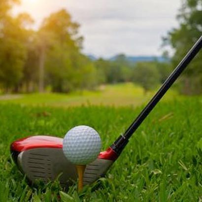 Golfer playing an 18-hole round at a lush tropical golf course in Bintan