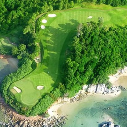 View of Laguna Golf Bintan with lush greens and stunning ocean backdrop, ideal for golfers of all skill levels