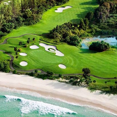 Panoramic view of Ria Bintan Golf Club with oceanfront fairways and lush greenery in Bintan