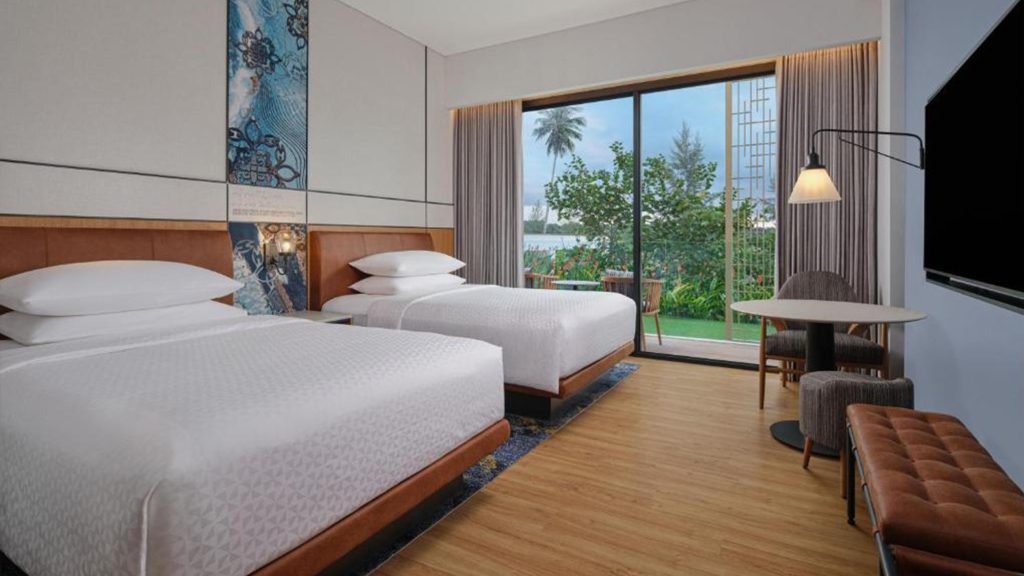 Golfers teeing off at Ria Bintan Golf Club with a luxurious stay at Four Points Bintan
