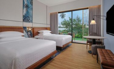 Golfers teeing off at Ria Bintan Golf Club with a luxurious stay at Four Points Bintan