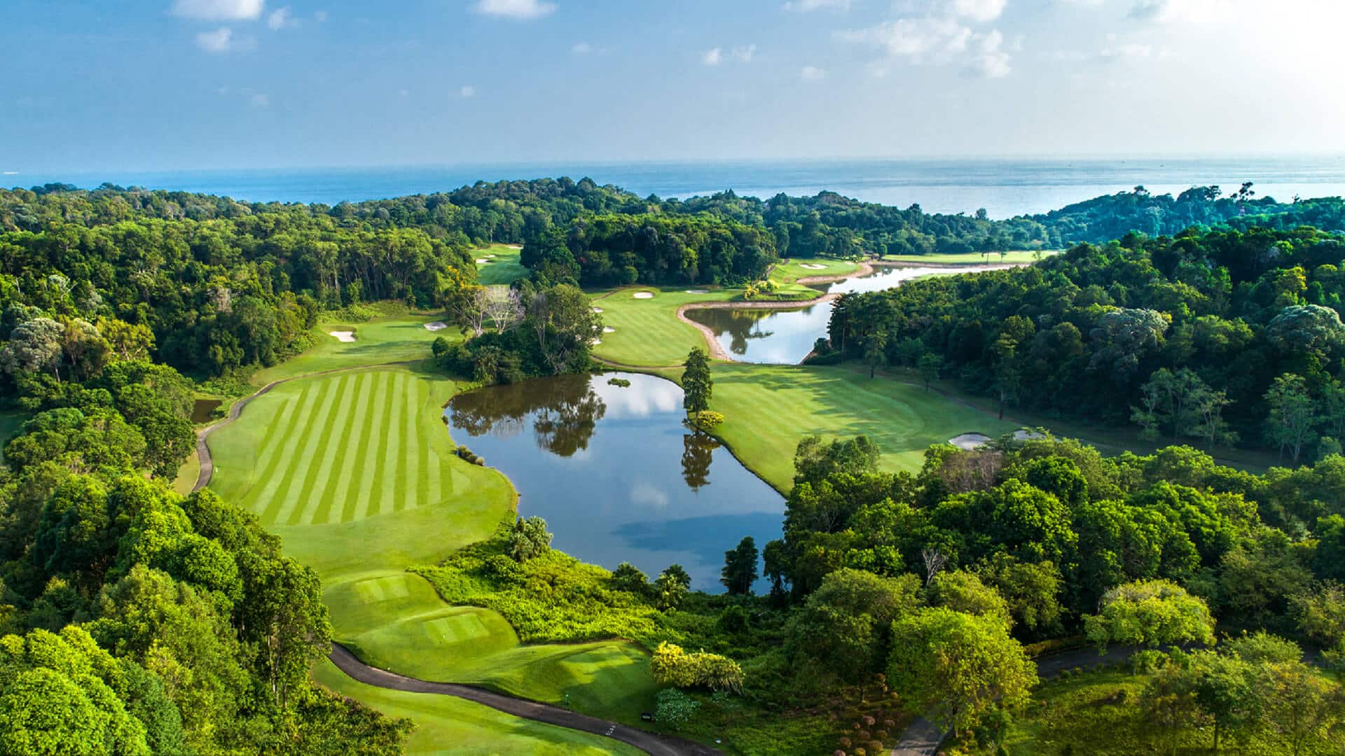 A panoramic view of Ria Bintan Golf Club course overlooking the ocean, a top destination included in Bintan golf packages from South Korea