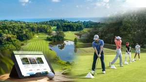 Korean golfer practicing on a lush tropical golf course in Bintan, Indonesia, with BintanRetreat.com booking app displayed on a phone in the foreground.